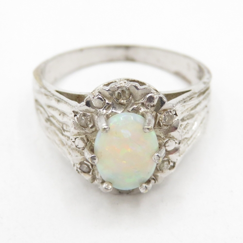 107 - 9ct white gold opal and diamond halo ring (2.6g) Size L