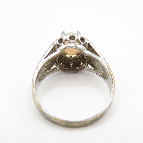 107 - 9ct white gold opal and diamond halo ring (2.6g) Size L