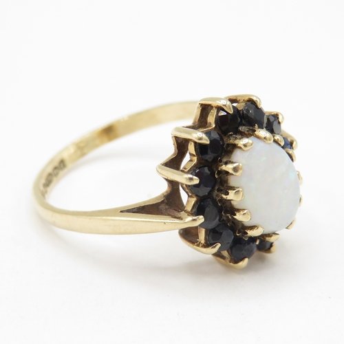 109 - 9ct gold opal and sapphire halo dress ring  (3.1g) Size R
