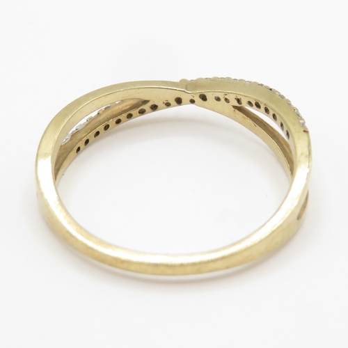 143 - 9ct gold diamond crossover ring  (1.3g) Size J 1/2