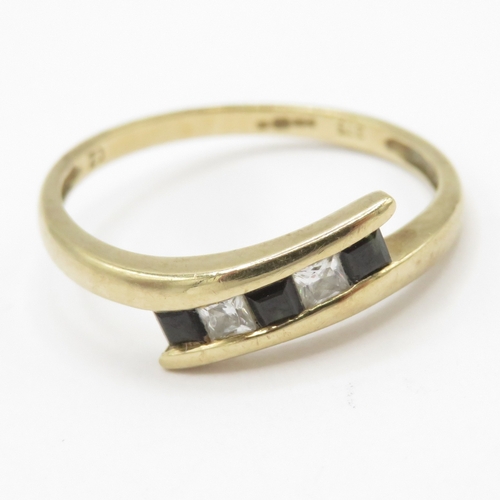 154 - 9ct gold topaz and white gemstone bypass ring (1.6g) Size N