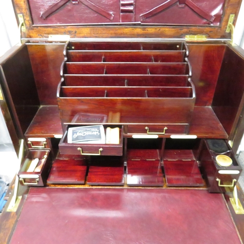 280 - A gentleman's compendium with lock stand and has front opening with campaign handles.  In good condi... 