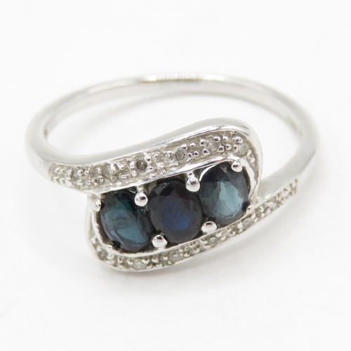 95 - 9ct white gold diamond sapphire crossover ring (1.9g) Size L
