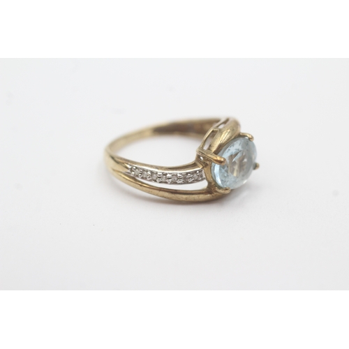 102 - 9ct gold aquamarine diamond crossover ring (2.6g) Size N
