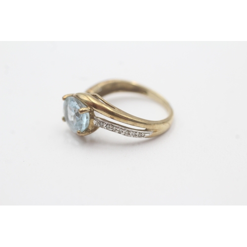 102 - 9ct gold aquamarine diamond crossover ring (2.6g) Size N