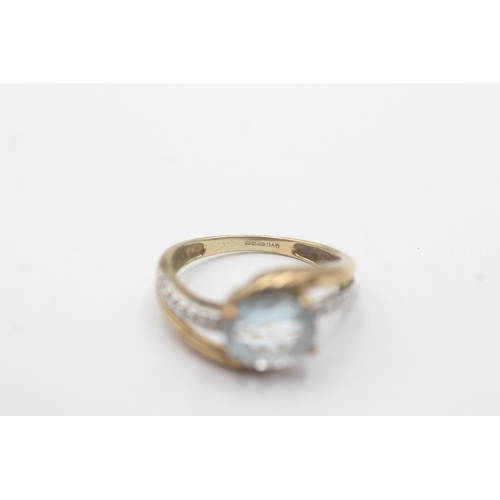 102 - 9ct gold aquamarine diamond crossover ring (2.6g) Size N