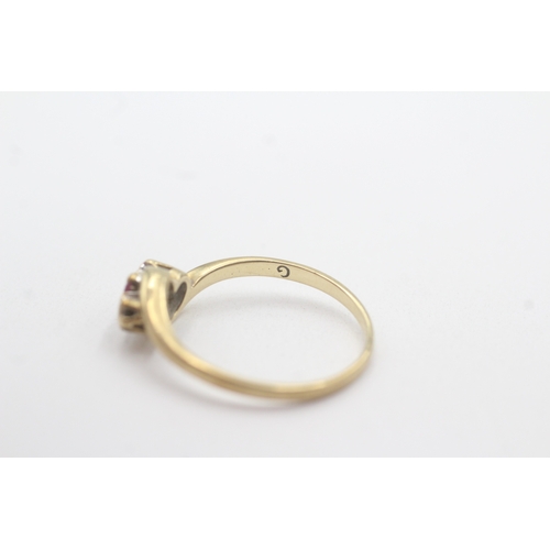 114 - 9ct gold ruby diamond trilogy bypass ring (1.7g) Size O