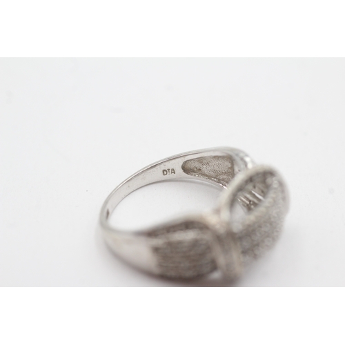 124 - 9ct white gold diamond dress ring (5.3g) Size P