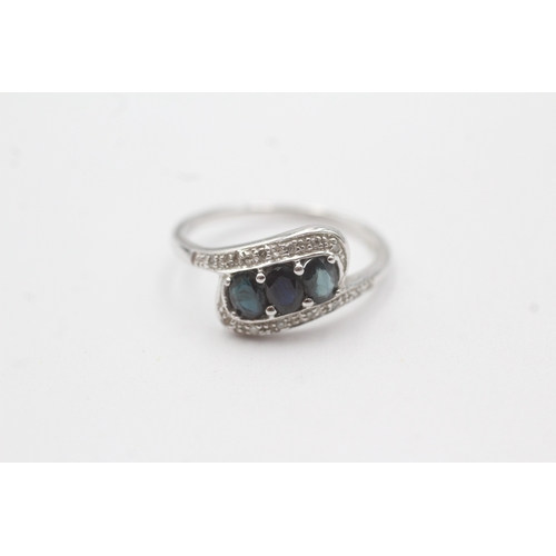 95 - 9ct white gold diamond sapphire crossover ring (1.9g) Size L