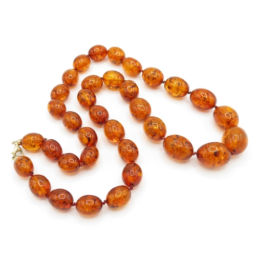 98 - 9ct gold amber necklace (51.9g)