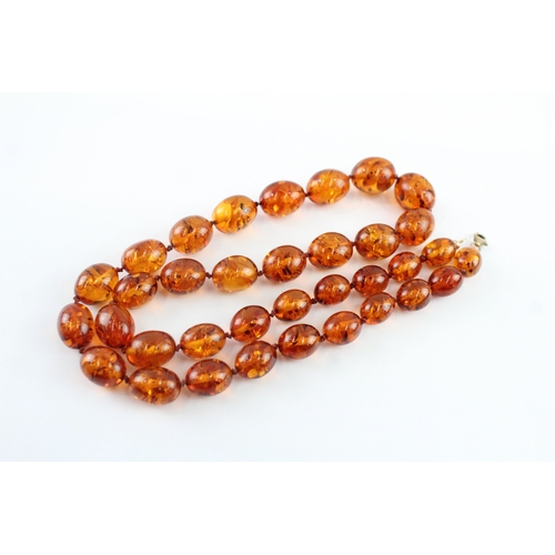 98 - 9ct gold amber necklace (51.9g)
