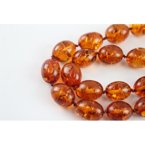 98 - 9ct gold amber necklace (51.9g)