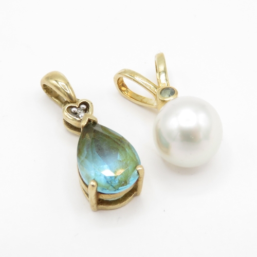 70 - 2x 9ct gold cultured pearl, emerald, topaz & diamond pendants (2.9g)