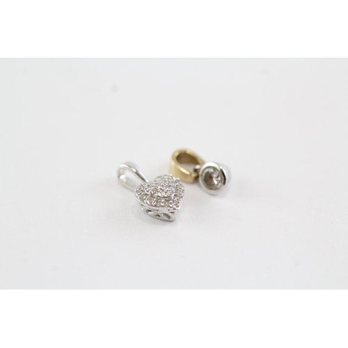53 - 2x 9ct gold diamond pendants (1g)
