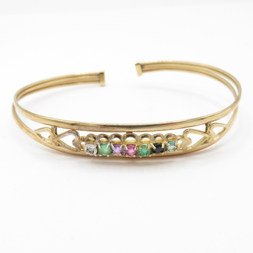 24 - 9ct gold acrostic 'DEAREST' bangle, including diamond emerald ruby sapphire (5g)