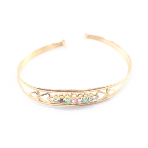 24 - 9ct gold acrostic 'DEAREST' bangle, including diamond emerald ruby sapphire (5g)