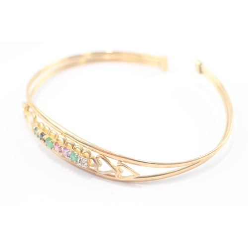 24 - 9ct gold acrostic 'DEAREST' bangle, including diamond emerald ruby sapphire (5g)