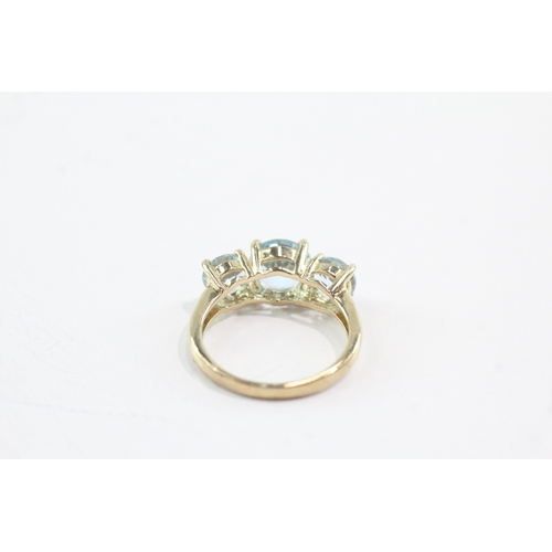 50 - 9ct gold topaz three stone ring (3.4g) Size N