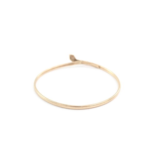 11 - 9ct gold ruby eyes snake bangle (5g)