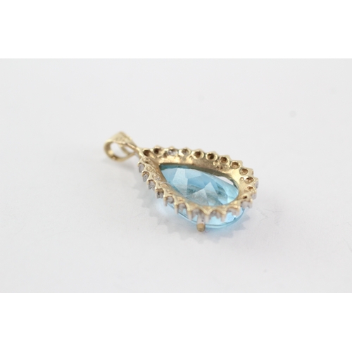 25 - 9ct gold blue topaz pear cut diamond halo cluster pendant (2.4g)