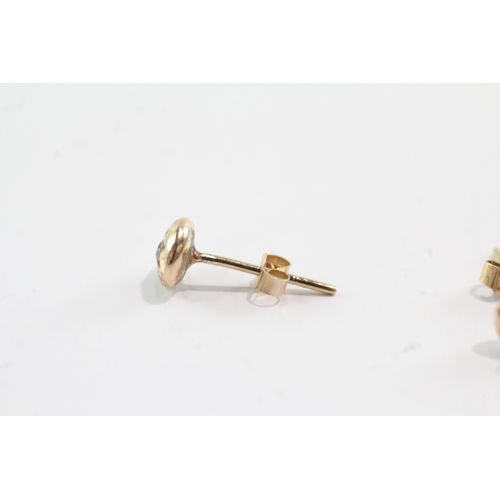 54 - 9ct gold diamond gypsy studs (1.6g)