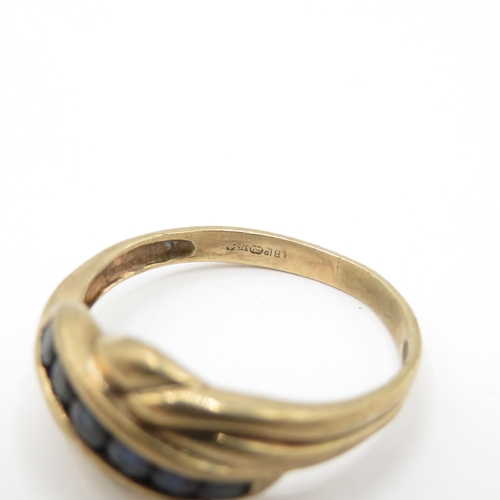 57 - 9ct Gold Sapphire Channel Set Twist Ring (2.5g) Size P