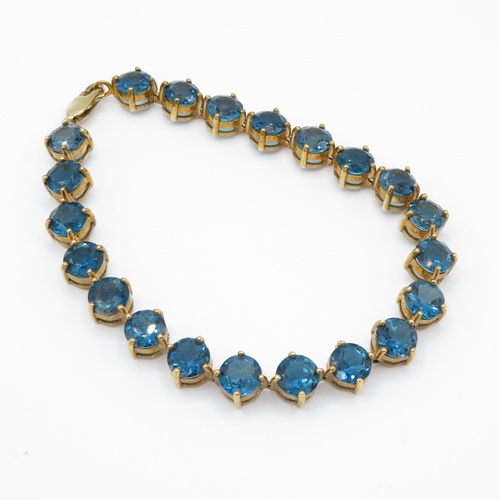 7 - 9ct gold blue topaz line bracelet (19.4g)