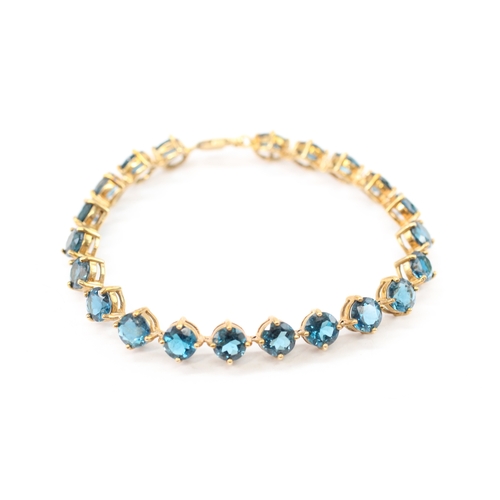 7 - 9ct gold blue topaz line bracelet (19.4g)