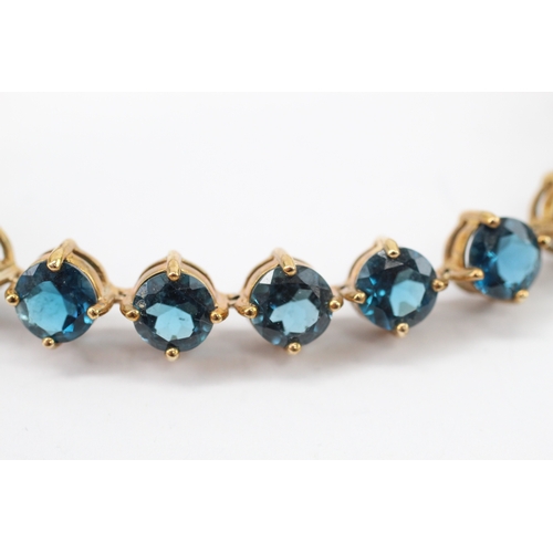 7 - 9ct gold blue topaz line bracelet (19.4g)