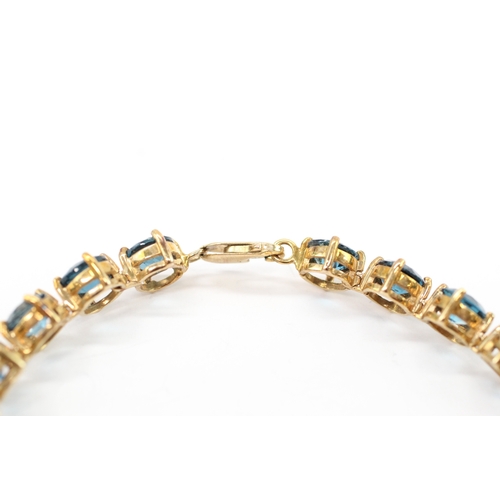 7 - 9ct gold blue topaz line bracelet (19.4g)