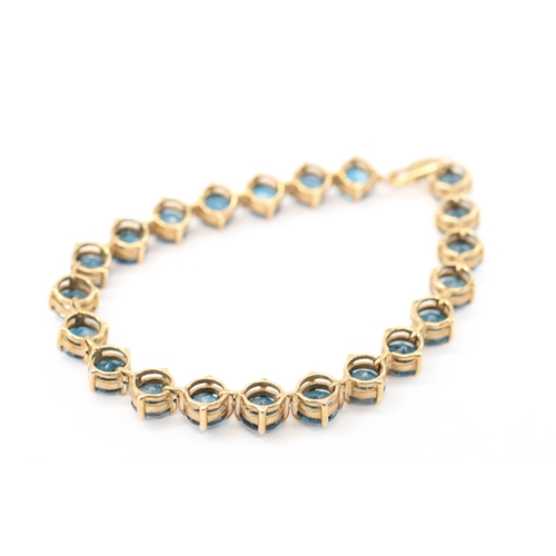 7 - 9ct gold blue topaz line bracelet (19.4g)