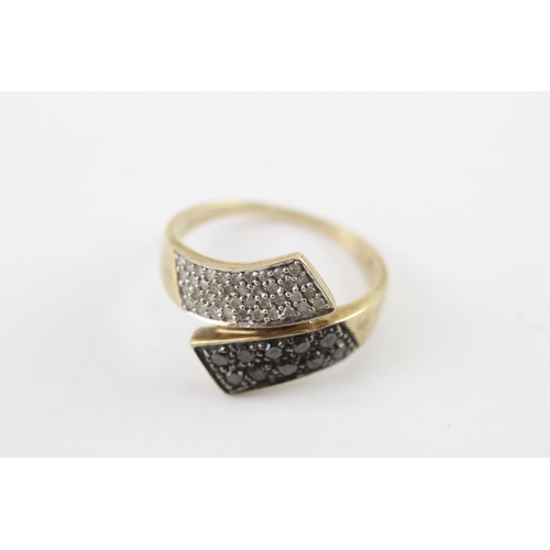15 - 9ct gold black gem and diamond bypass ring (3.6g) Size P 1/2