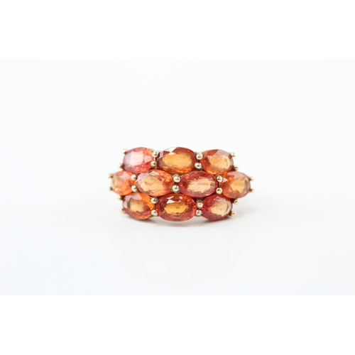 48 - 9ct gold colour enhanced orange sapphire ring (3.5g) Size K