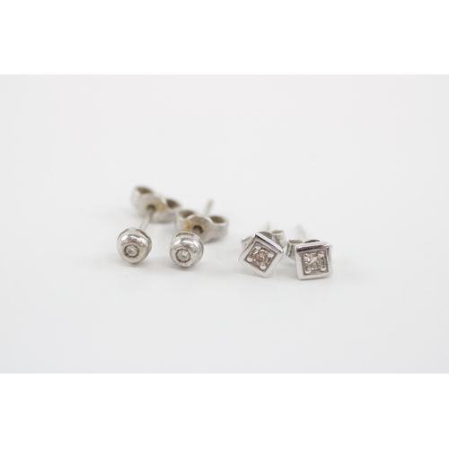 57 - 2x 9ct white gold diamond stud earrings (1.4g)
