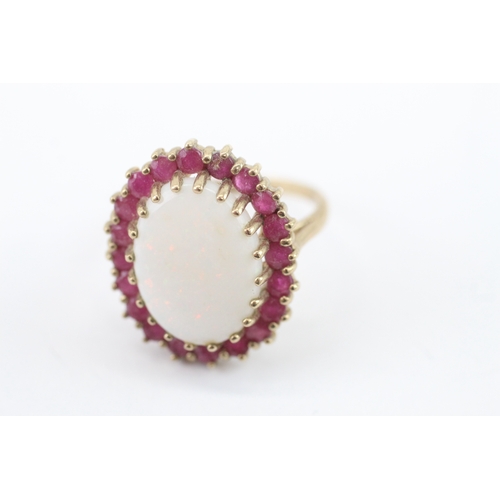 59 - 9ct gold opal and ruby halo statement ring (4.95g) Size P