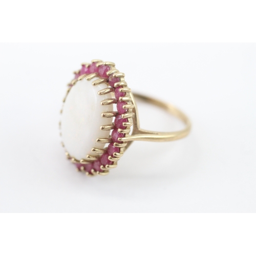 59 - 9ct gold opal and ruby halo statement ring (4.95g) Size P