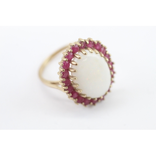 59 - 9ct gold opal and ruby halo statement ring (4.95g) Size P