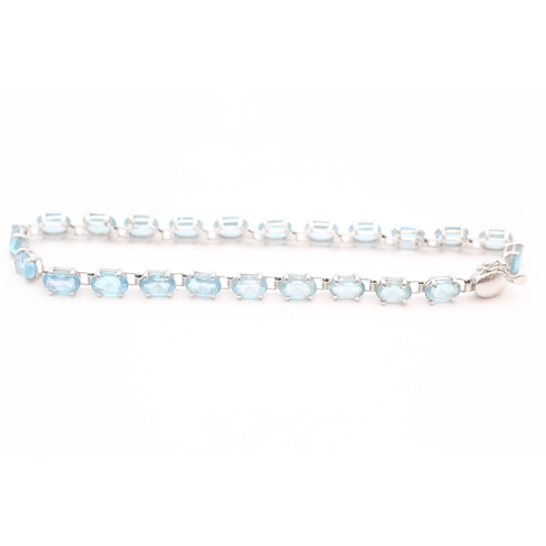 43 - 9ct white gold blue topaz set tennis bracelet (5.2g)