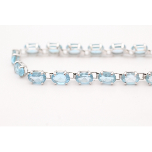 43 - 9ct white gold blue topaz set tennis bracelet (5.2g)