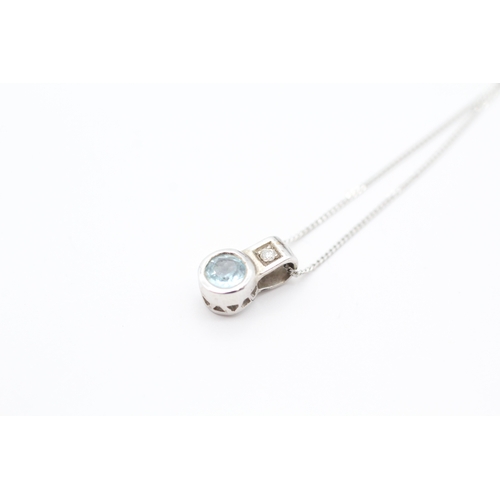 47 - 9ct white gold diamond and blue topaz pendant necklace (1.6g)