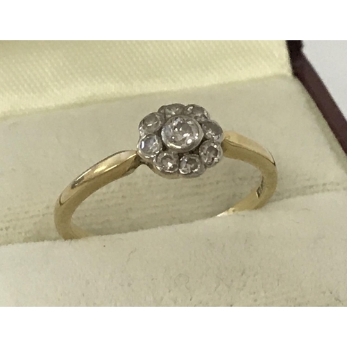 11 - A vintage Art Deco style 18ct diamond set dress ring of flower head design. Central round cut diamon... 