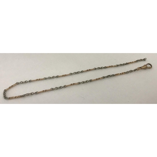 20 - A Decorative rose and white gold watch chain with lobster clasp. Ring fixing missing from end. Tests... 
