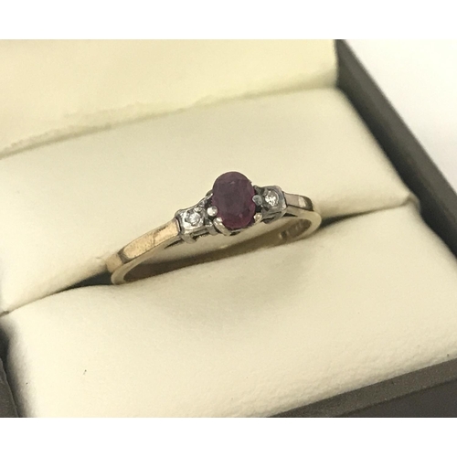 21 - A vintage 9ct gold ruby and diamond dress ring. Central oval cut ruby with a small diamond to each s... 
