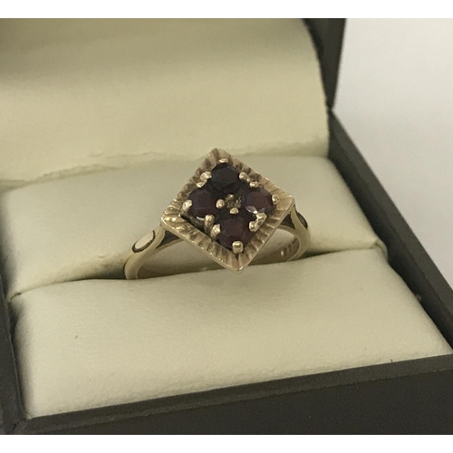 28 - A 9ct gold vintage style, garnet set dress ring. Diamond shaped mount set with 4 round cut garnets. ... 