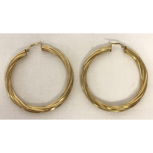 38 - A large pair of 9ct gold twist style hoop earrings by Unoaerre. Fully hallmarked on hooks. Total wei... 