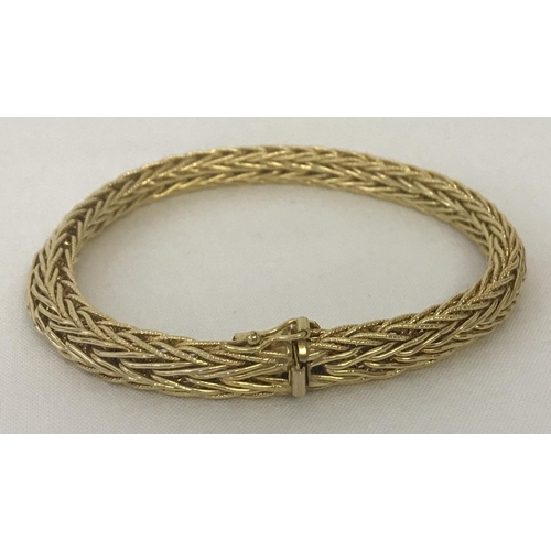 4 - A 9ct gold bracelet with plaited wheat style chain and push clasp and safety clip.Marked 375 and mak... 