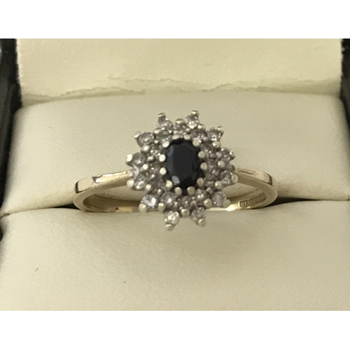 46 - A 9ct gold sapphire and diamond dress ring. Central oval cut sapphire surrounded by two rows of smal... 