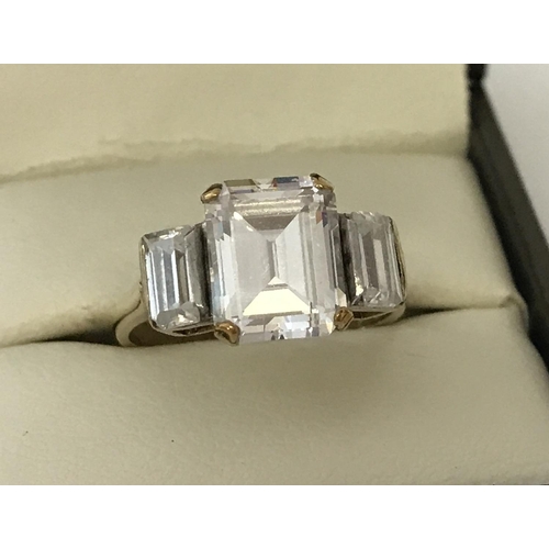 52 - A 9ct gold large clear stone set trilogy ring. Central octagon cut stone with 2 baguette cut stones.... 