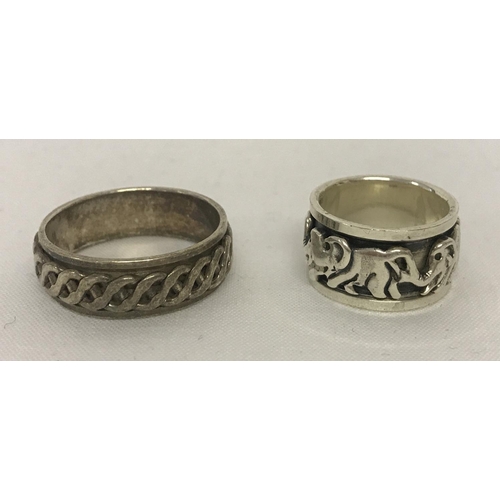 1015 - 2 silver spinner band rings. One with elephant decoration the other with a Celtic design. Sizes K½ a... 