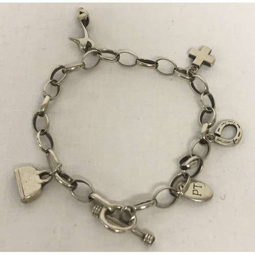 1018 - A vintage style belcher chain charm bracelet with charms. To include shoe, handbag and cross. One li... 